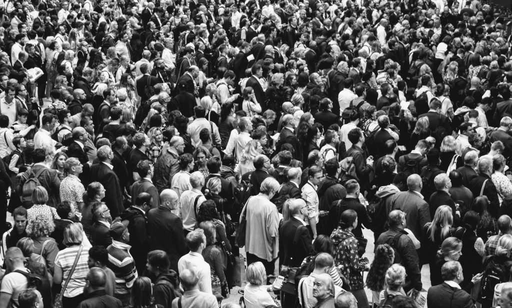 A sea of people crossing a road.