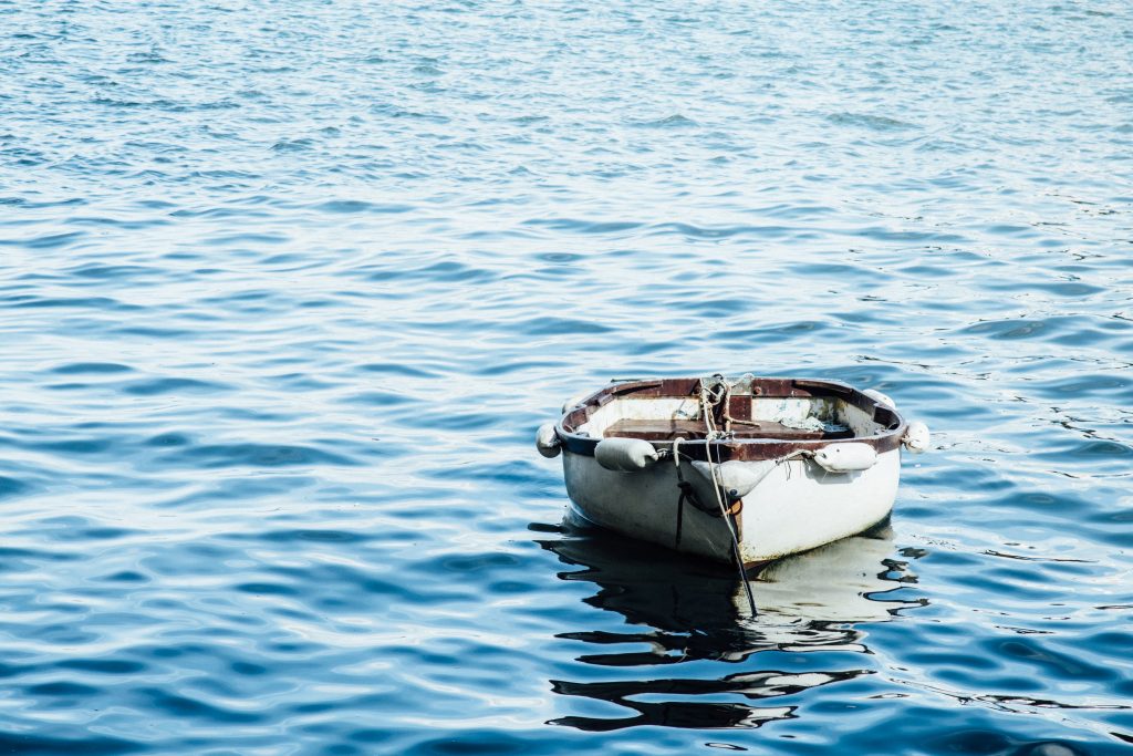 A boat sitting in the middle of a body of water.